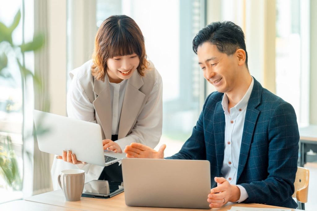 上司に意見をもらいながら仕事をする女性